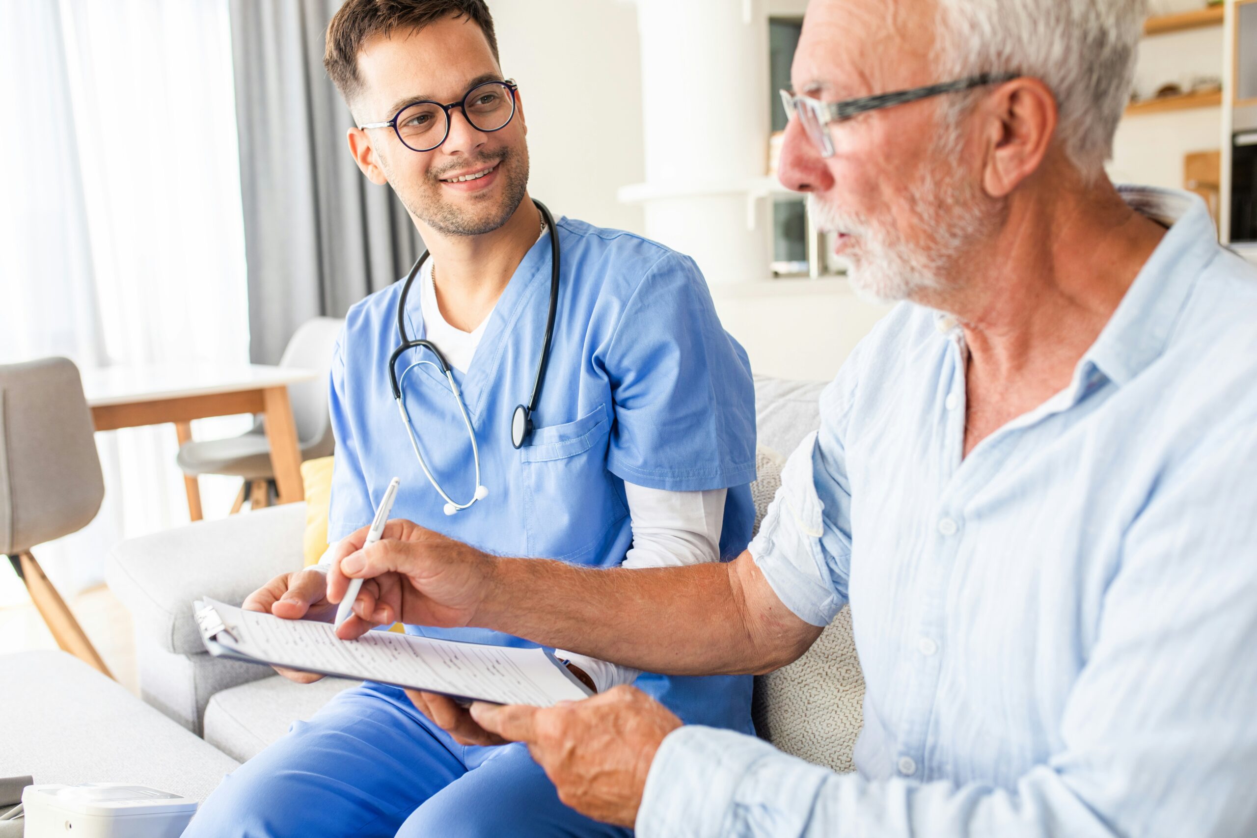 Doctor discussing medical care with an elderly patient during a healthcare consultation, focusing on patient communication and support.